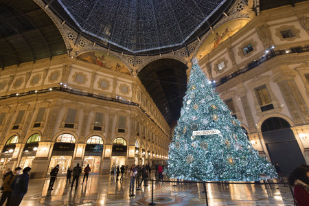 Milan, Italy - December 10, 2020: street view of the Christmas tree in Galleria Vittorio Emanuele at night, few people are barely visible in the distance.のeditorial素材