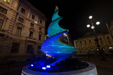 Milan, Italy - December 10, 2020: street view of the Christmas tree in Galleria Vittorio Emanuele at night, few people are barely visible in the distance.のeditorial素材