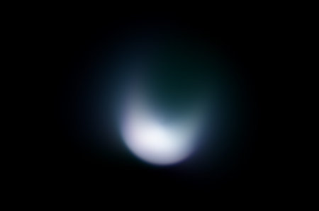 Coloured optical lens flare on black background.