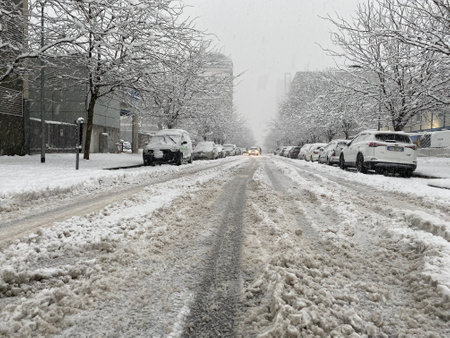 Milan, Italy - December 28, 2020: street view of Milan during the snow blizzard of late December, people are visible in the distance.のeditorial素材