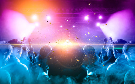 Many people together in front of harsh lights, lens flare is visible.の写真素材