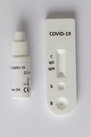 Close up on a Covid-19 test resting on a white background.
