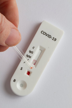 Close up on a Covid-19 test resting on a white background.