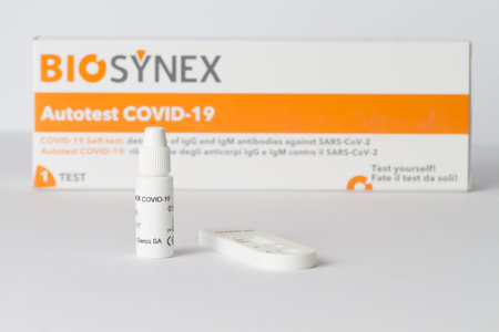 Close up on a Covid-19 test resting on a white background.のeditorial素材