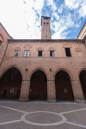 Cremona, Italy - June 2, 2021: Front view of Santa Maria Assunta cathedral, people are visible in the distance. Shot is taken during daylight, background is a cloudy blue sky.のeditorial素材