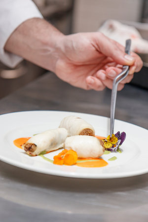 Chef preparing food in the kitchen at the restaurant. Food styling and restaurant meal serving...