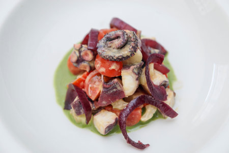 Seafood salad with octopus, squid, mussels and red onion
