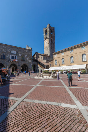 Bergamo, Italy - July 10, 2021: street view of Bergamo Alta citadel in full daylight, people are visible in the distance.のeditorial素材