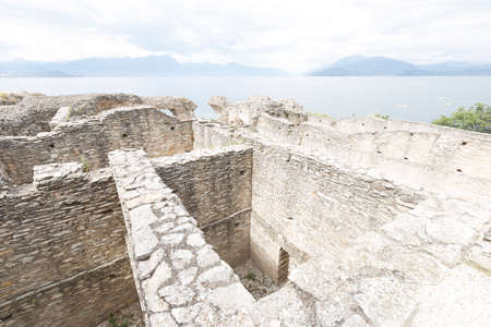 Sirmione, Italy - July 18, 2021: street view of Sirmione on Garda Lake, the castle Rocca Scaligera is visible.のeditorial素材