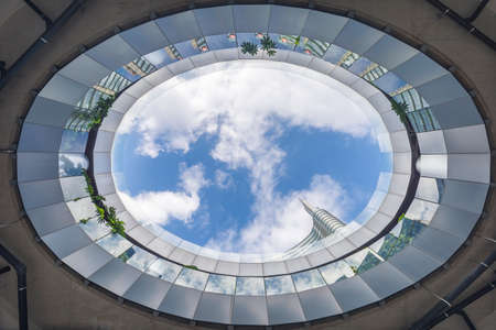 Milan, Italy - October 9, 2021: low angle view of Piazza Gae Aulenti in Milan, no people are visible. Cloudy blue sky is visible above.のeditorial素材