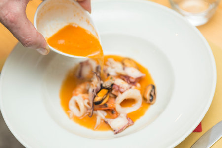 Close up on an italian gourmet seafood recipe, served on a restaurant table.