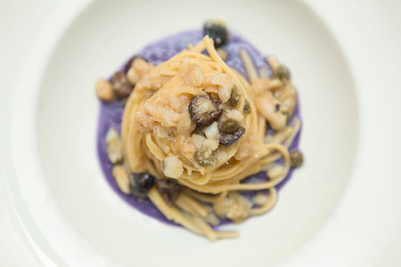 Close up on an italian gourmet seafood recipe, served on a restaurant table.