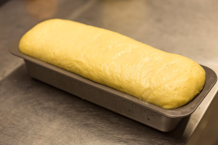 Freshly baked loaf of bread on a baking sheet in a bakery