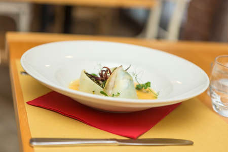 Close up on an italian gourmet seafood recipe, served on a restaurant table.の写真素材