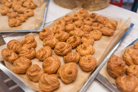 Cream puff pastry on the counter of a bakery shop close-up