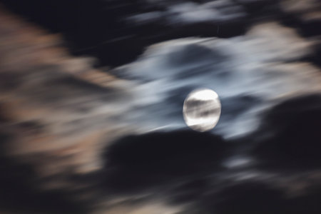 Long telephoto lens shot of the moon in a black sky.の写真素材