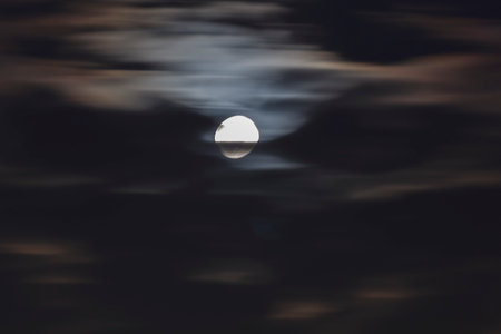 Long telephoto lens shot of the moon in a black sky.の写真素材