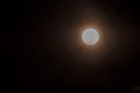 Long telephoto lens shot of the moon in a black sky.