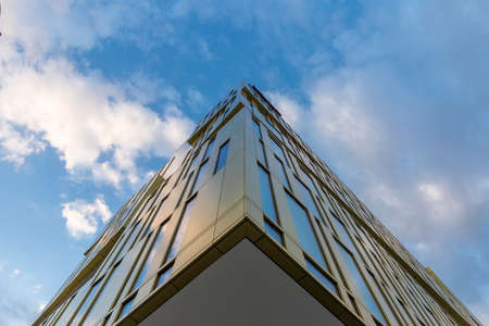 Milan, Italy - February 25, 2022: street view of sunset in Milan architecture with a brand new golden office building in Romolo area. No people are visible.のeditorial素材