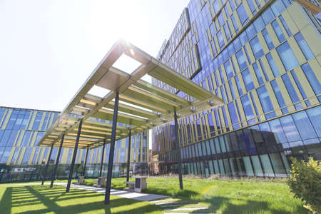 Milan, Italy - April 25, 2022: street view of sunset in Milan architecture with a brand new golden office building in Romolo area. No people are visible.のeditorial素材