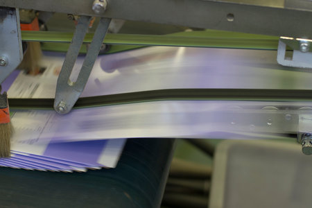 Close up detail of cartographic industrial machinery at work in a production line, conveyor belts are visible, no people are present.の写真素材