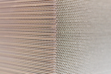 Industrial paper cardboard stock piled up, no people are visible.