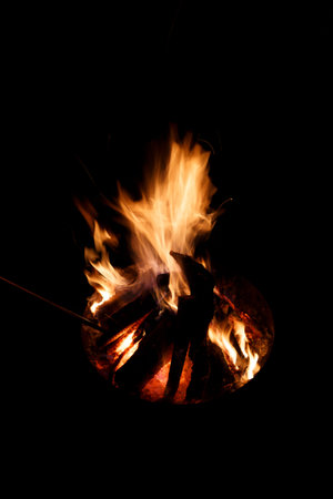 Bonfire on a black background. The fire is burning in the night.