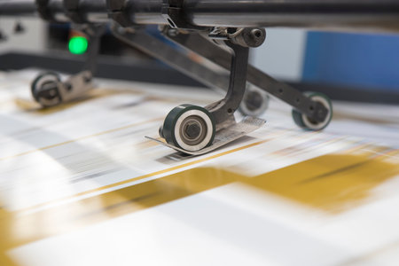 Close-up image of a printing machine. Printing and processing of printed products.