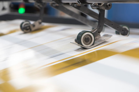 Close-up image of a printing machine on a white background.