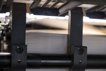 Close-up of a conveyor belt with sheets of paper.の写真素材