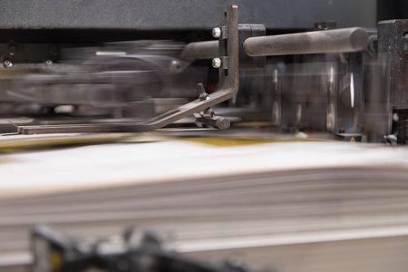 Close-up of a printing machine and sheets of paper. Selective focus.の写真素材