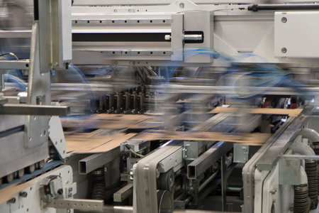 Close up detail of industrial machinery at work in a production line, conveyor belts are visible, no...