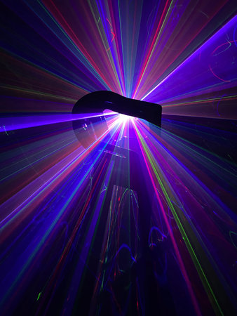 Colorful laser light beam photographic effect on black background. Nobody is visible.の写真素材