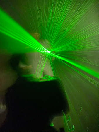 Colorful laser light beam photographic effect on black background. Nobody is visible.の写真素材