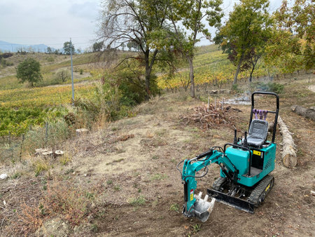 Tractor working in the vineyard on a sunny autumn day.の写真素材