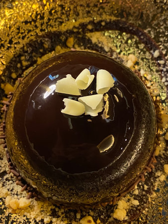 Chocolate mousse cake with almonds on a dark wooden background.の写真素材
