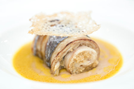 Close up on a fine gourmet dish served on a restaurant table, no people are visible.の写真素材