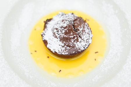 Chocolate dessert on a white plate, close-up.の写真素材