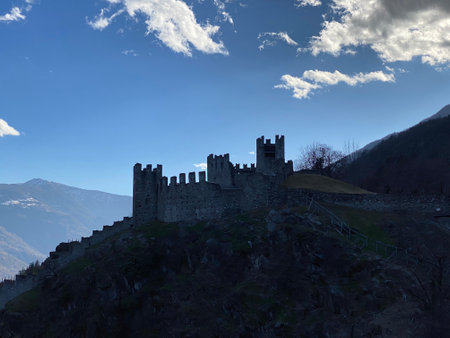 Castle on the top of a hill with blue sky and cloudsの写真素材