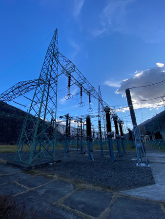 High voltage power lines against the blue sky, closeup of photoの写真素材