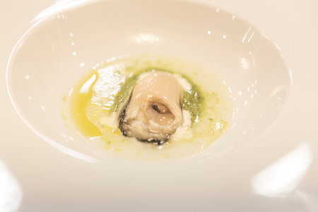 Steamed herring with oyster sauce in white bowl.の写真素材