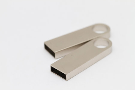 Macro shot of USB pen drive resting on a studio background.