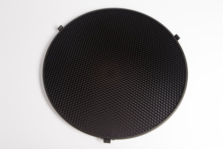 Close up of a black perforated metal grill on white backgroundの写真素材