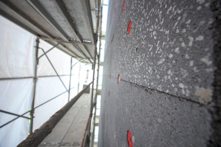 Thermal and acoustic insulation materials like polystyrene foam, mineral wool and polyurethane foam, applied outside a residential building.の写真素材