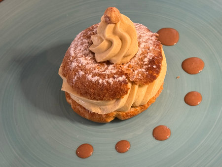 Pastry with cream on a blue plate.の写真素材