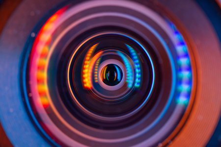 Close-up of a camera lens with multicolored lights.