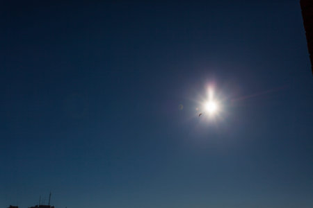 Sun in the blue sky with white clouds. The sun is shining.