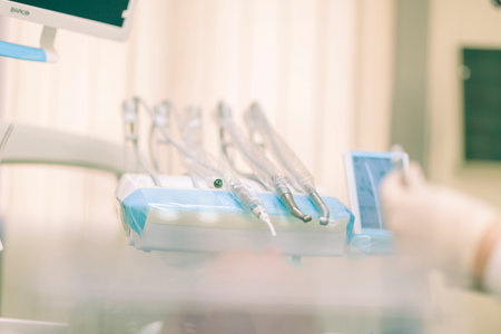 Detail of a dentist performing surgery with anesthesia on a patient for root canal treatment and...