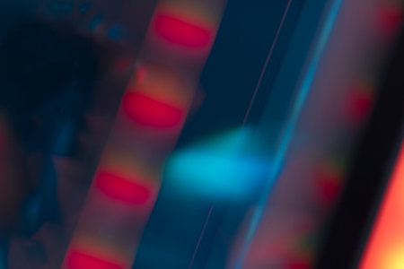 Overlay of a light leak coloured in red and cyan hues. Background is dark.の写真素材
