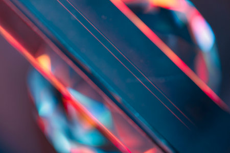 Overlay of a light leak coloured in red and cyan hues. Background is dark.の写真素材